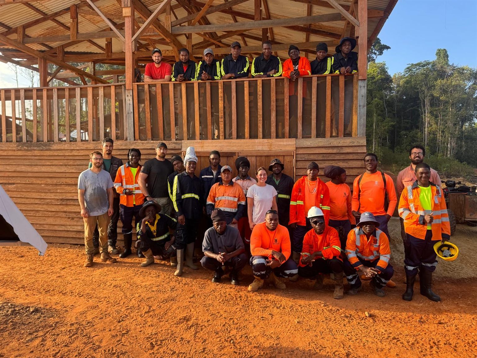 Miata's geologists and the Suriname drill and field crew, around thirty people, gathered in front of the timber camp building at Sela Creek, September 2026