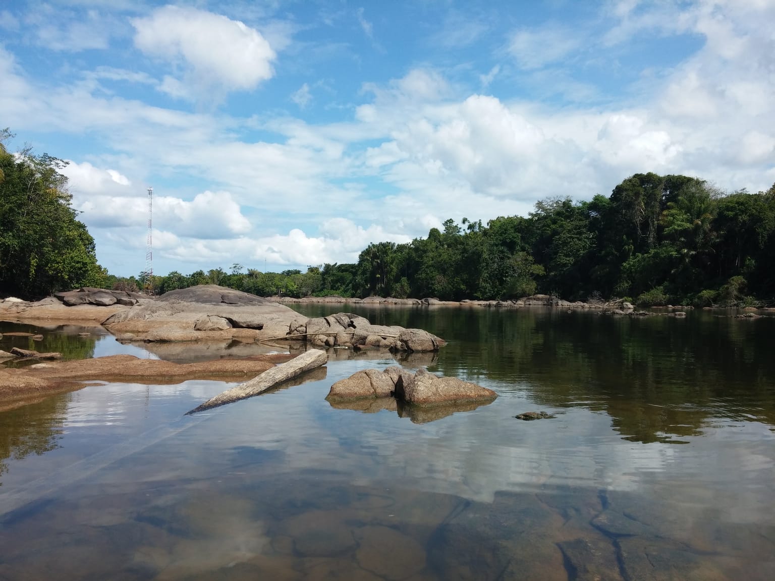 A glassy river running over granite boulders at Paaston, Sela Creek